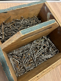 Different nails in a wooden box