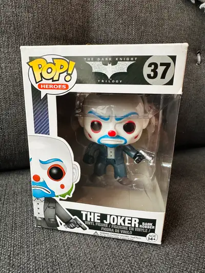 I'm offering a used Funko Pop! Heroes The Dark Knight Trilogy #37 - The Joker (Bank Robber) vinyl fi...