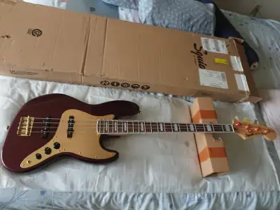 Selling brand new Fender Squire 40th Anniversary Jazz Bass Gold Edition, Ruby Red Metallic. Killer b...