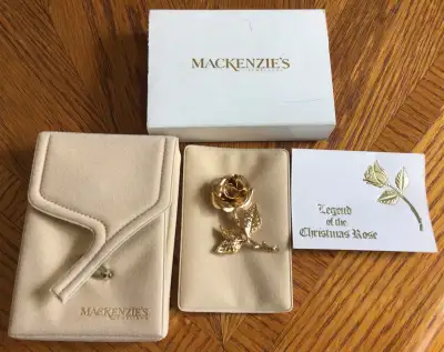 Christmas rose brooch, gold tone, shiny finish. Size: 25/8 inches long x 7/8 of an inch at widest po...