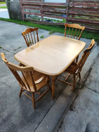 Solid wood dining table and 4 chairs. Great quality condition. Includes 2 leafs to extend table leng...