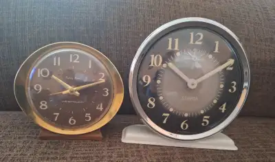 A pair of vintage alarm clocks. Both mechanical. 1. Westclox made in Canada 1960s 2. Sturm made in B...