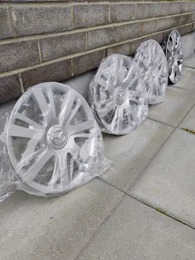 Selling a set of 4 Mazda-style hubcaps that came off a 2012 Mazda for $50 Good for 15-inch steel whe...