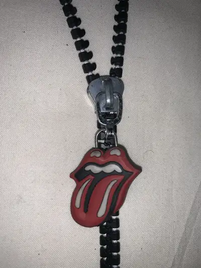 Rock out with this Rolling Stones "Sticky Fingers" tribute lanyard! This unique lanyard features a z...