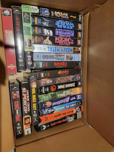I have a collection of VHS movies for sale, including titles like Star Wars, Jurassic Park, and Teen...