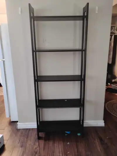 This used black shelving unit is perfect for adding storage and style to any room! With its sleek de...