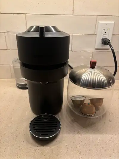 Approximately year and a half old Nespresso coffee maker. Works well, includes pod storage jar. Drip...