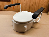 Toilet Seat Raiser with lift up arms.  From Invacare.