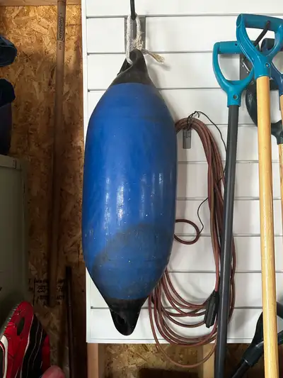 This is a used blue boat fender, perfect for protecting your boat from dock damage. It's in good con...