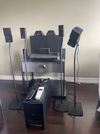 BOSE music center.  Seven Bose speakers and stands . 