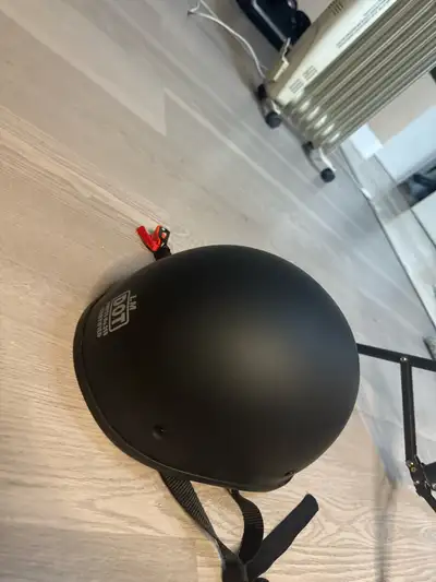 This matte black motorcycle helmet offers essential protection with a low-profile design. It is DOT...