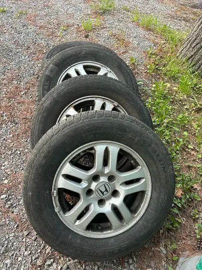 Offering a set of four used tires and rims that came off a Honda CRV, featuring General Altimax tire...