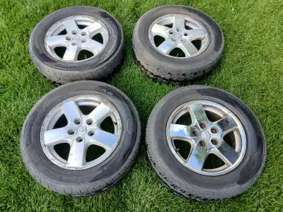 Four Tripletred Assurance Tires on rims from a Dodge Grand Caravan. Two tires are newer than the oth...