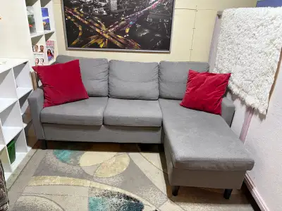 Grey reversible sectional couch in good condition , View more