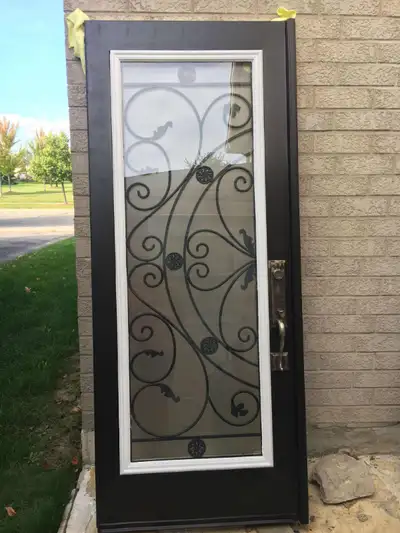 Used double entry doors with wrought iron glass inserts. Black Exterior; white interior. Glass measu...