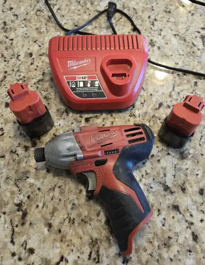 2 Milwaukee batteries + charger, View more