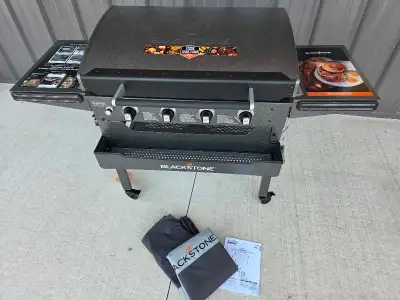 Get ready to grill with this Blackstone 4-Burner Propane Gas Griddle, equipped with a hood and two s...