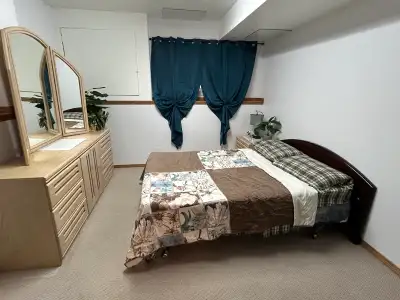 Private room for rent in a shared living space. The room is furnished with a bed and dresser. The ba...