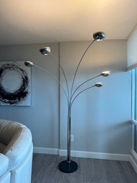 Overarching silver lamp with black base