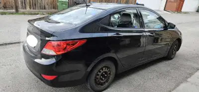 Selling a 2013 Hyundai Accent, a compact and reliable black car perfect for city driving and fuel ef...