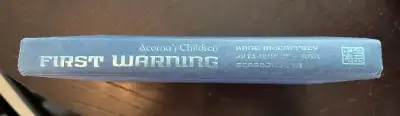First Warning: Acorna's Children Hardcover Book by Anne McCaffrey & Elizabeth Ann Scarborough. Messa...