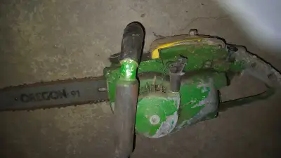 This vintage chainsaw is a true piece of history, showcasing a rugged design and sturdy construction...