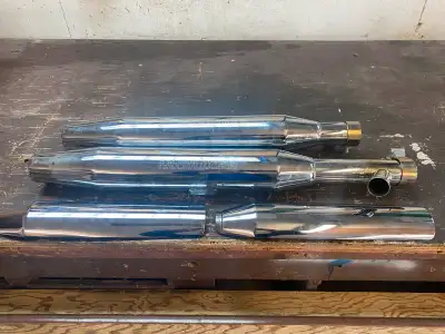 These are a pair of OEM exhaust pipes removed from a 2002 Harley-Davidson Fatboy. The pipes are used...