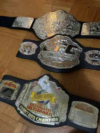 3 plastic belts. UFC & WWE