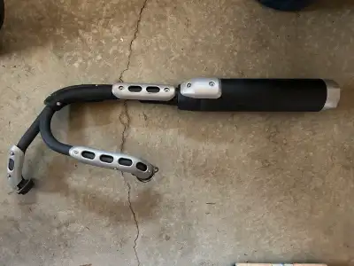 Stock exhaust piping and muffler from a 2014 Yamaha Bolt in used but fair condition.