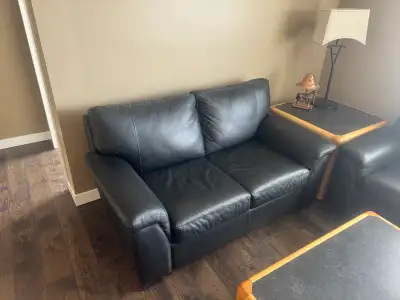 Elevate your living space with this stylish Leon's Icon black leather sofa and loveseat set only a y...