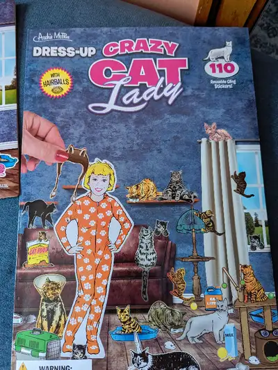 Cut out doll kit comes with cat lady doll, background display showing a living room, and two sheets...