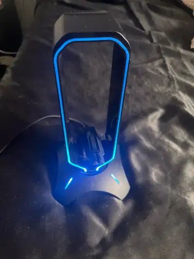 This is a used headphone stand with RGB lighting, perfect for keeping your gaming setup organized an...