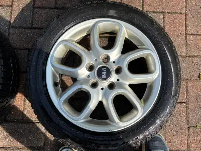 A set of four Pirelli Winter 210 Snowcontrol Series 3 run-flat tires on OEM Mini Cooper 16-inch rims...
