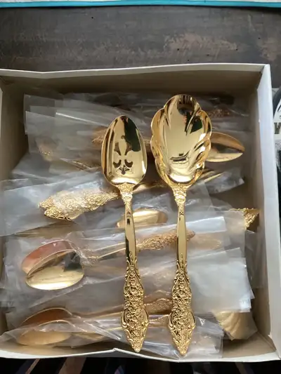 Full set forks knives and 2 spoons with serving set in gold plated over metal. Has been around for a...