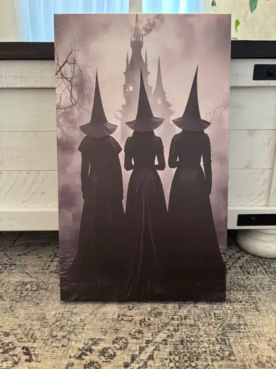 This captivating canvas features three witches in silhouette against a spooky castle backdrop, ready...