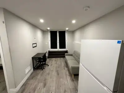 1-bedroom walkout basement suite with a separate entrance available featuring a living area, kitchen...