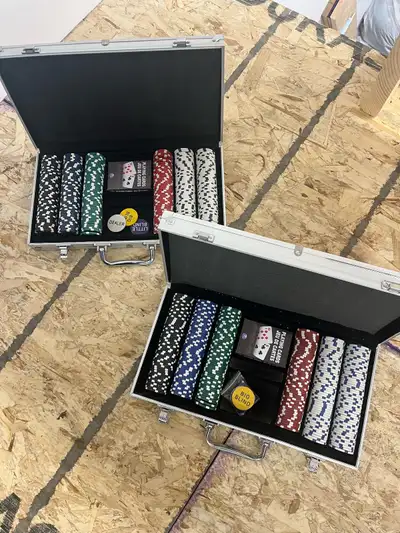 Slightly used poker chip sets. 2 sets of 300 playing chips, deck of cards, dealer chips, and metal c...