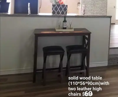 Solid wood table with two leather chairs $60, View more