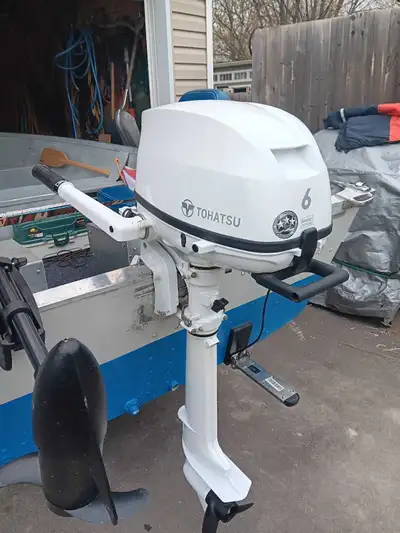2021 Tohatsu 6hp longshaft 4 stroke outboard motor with tank and hose. Used one time and saw it need...