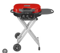 A brand new coleman road trip grill is for sale.