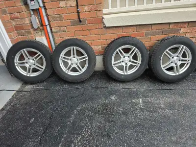 Set of 4 winter tires mounted on alloy rims, previously used on a Chrysler Pacifica. Tire size: 235/...