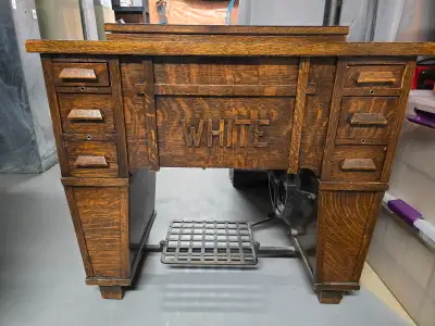 Beautiful early 1900s White Rotary sewing machine set in a solid oak treadle cabinet. This is a comp...
