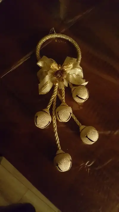 Gold coloured ring with gold strings and bells. Christmas decoration.