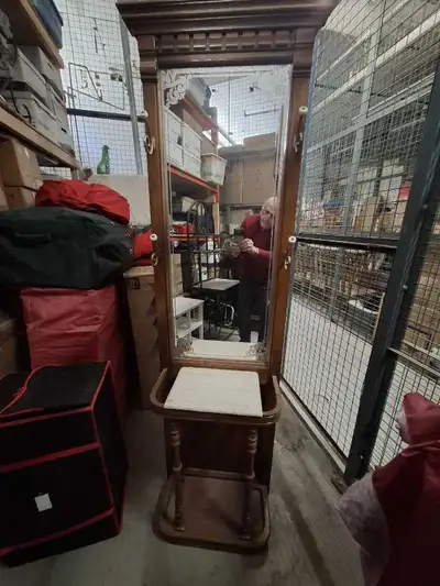 This is a wooden mirror, coat, and umbrella stand. It's in good condition, with some wear that adds...