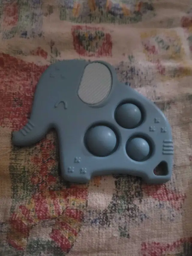 Itzy Ritzy Itzy Pop Teether in the shape of an elephant.