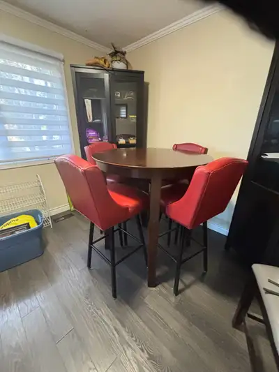 Real wood bar height table with 4 red leather chairs Chairs are very stable, comfortable and in grea...