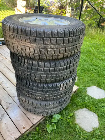 4 aluminum rims with mud and snow tires. 235/70/R16. Plenty of tread left.