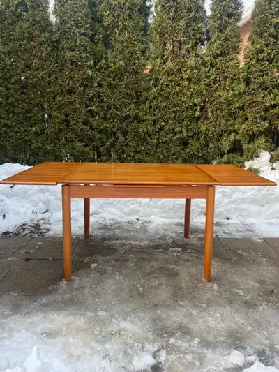 Selling a Mid Century Modern teak dining table possibly from Denmark with built in extension leaves...
