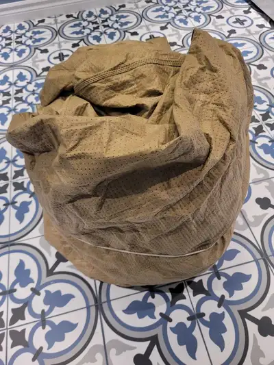 Small car cover. Has one small tear.
