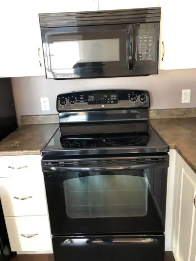 Open concept spacious living room/kitchen,kitchen with lots of cupboards ,including breakfast bar/is...